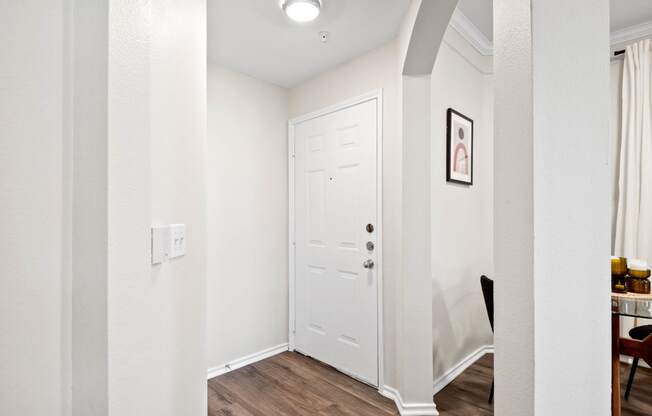 a hallway with a white door and white walls and a door to a closet at Mission Gate, Plano, TX, 75024