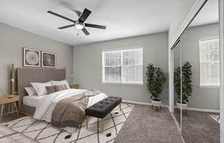 an open bedroom with a large bed and a ceiling fan
