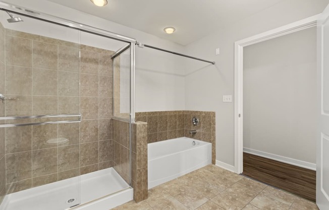 a bathroom with a tub and a shower and a sink