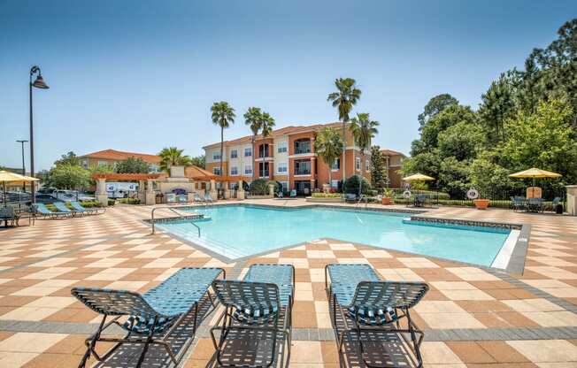 Pool area with view of the exterior building at Rapallo Apartments in Kissimmee, Florida