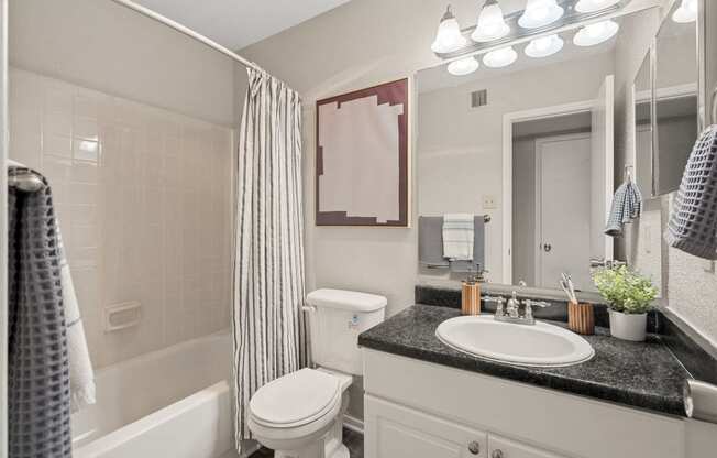 a white bathroom with a white toilet and a sink