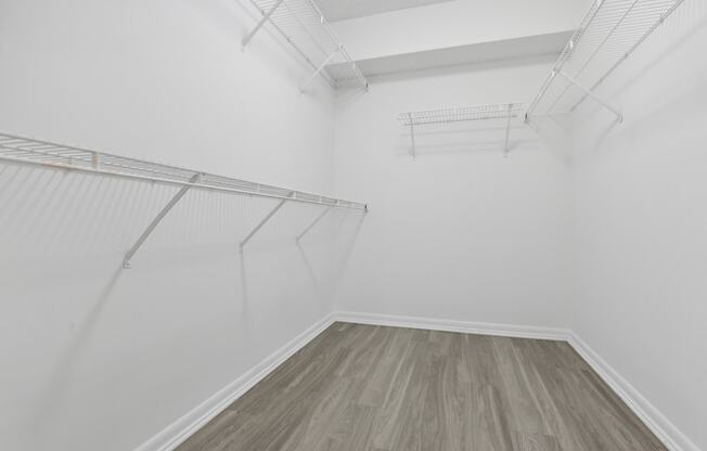 a room with white walls and wood floors and a white closet at Pembroke Pines Landings, Pembroke Pines, Florida