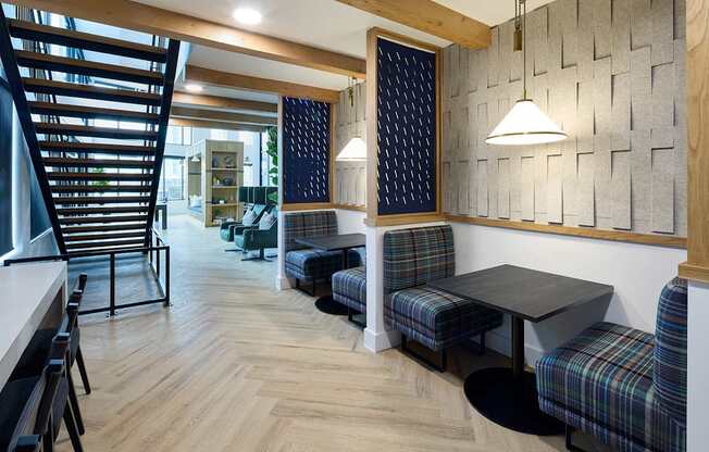 A room with a wooden floor and a wall with a patterned tile design.