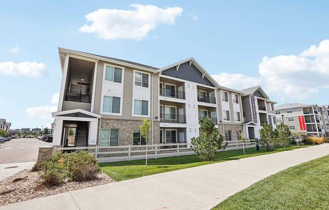 Apartment building with a clear blue sky above. at Connect at First Creek Apartments, Denver, CO