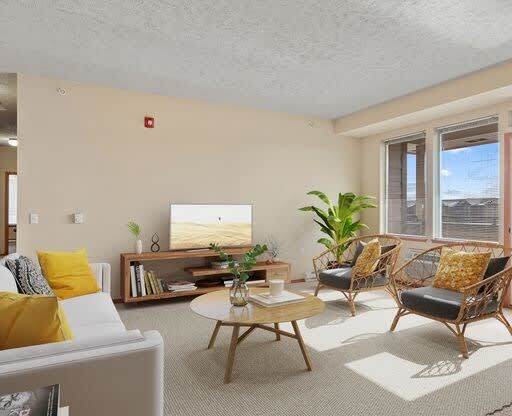 a living room filled with furniture and a flat screen tv