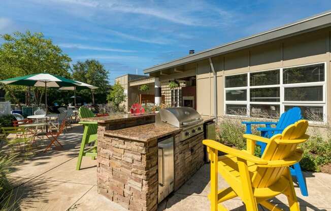 a backyard with a barbecue grill and chairs at Village Club of Royal Oak, Royal Oak, 48067