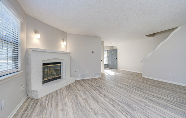 Townhome platinum living room interior with wood burning fireplace at The Arbor in Blue Springs, MO