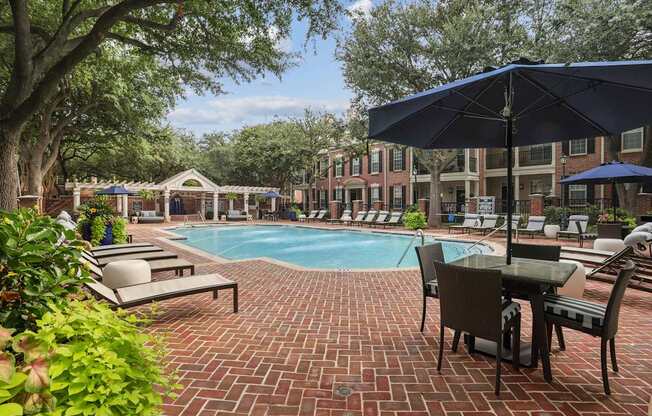 A pool surrounded by chairs and umbrellas.