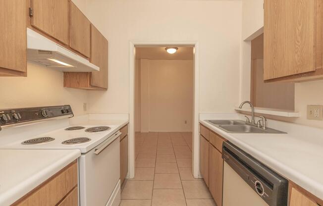 a kitchen with a stove sink and refrigerator