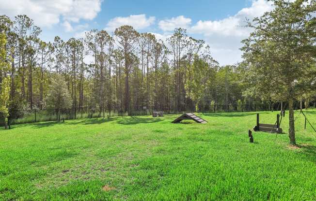 a grassy field with trees and a picnic table at Drift, Daytona Beach, FL, 32117