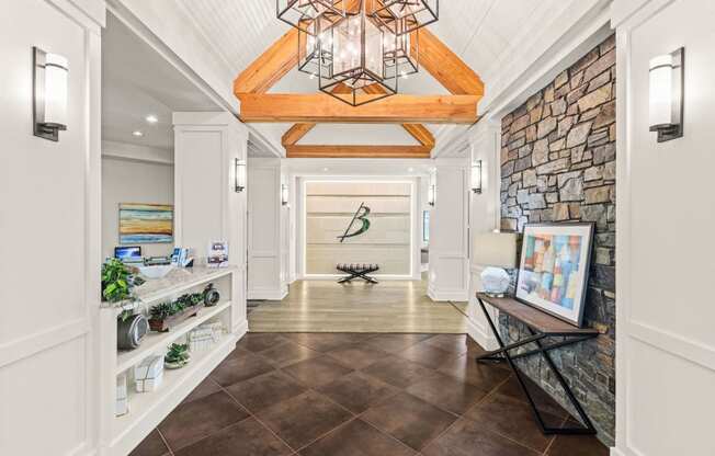 a long hallway with a stone wall and a vaulted ceiling with a light fixture