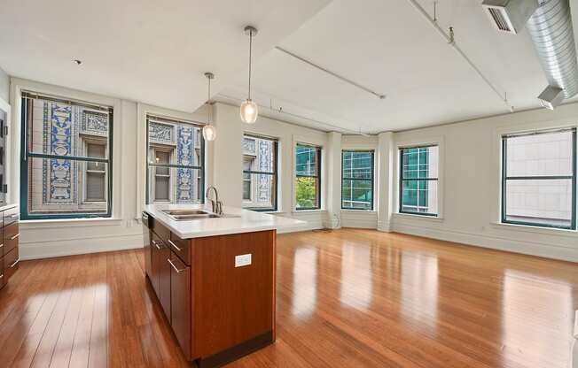 an empty kitchen with wood floors and a counter top