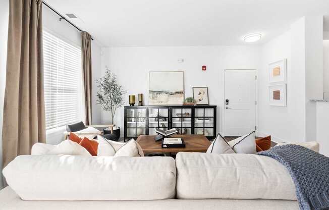 A living room with a white couch and a coffee table.