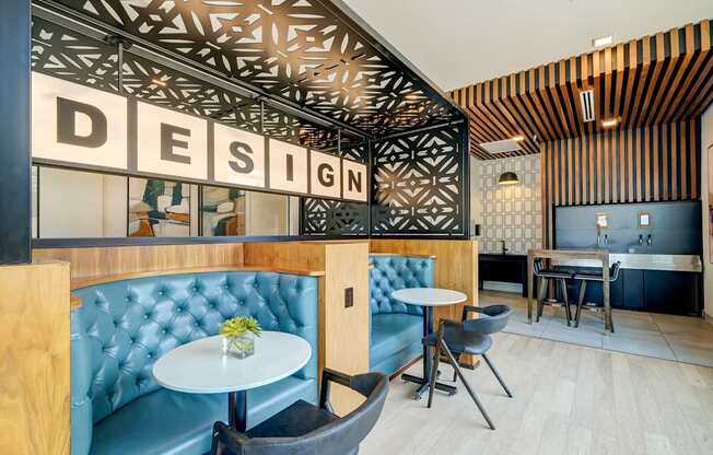 A modern cafe interior with a wooden ceiling and a sign that reads "DESIGN".
