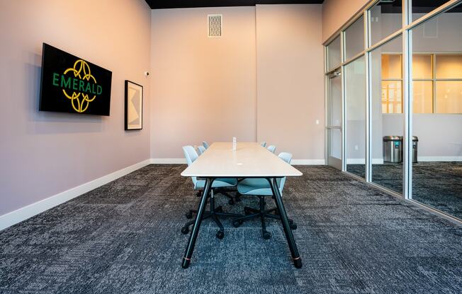 a meeting room with a white table and chairs