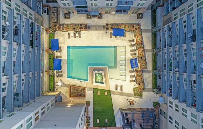 a birds eye view of a building with a pool in the middle