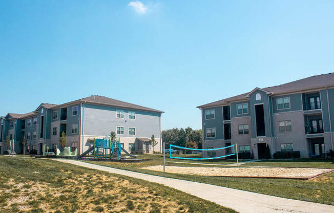 an image of an apartment building with a playground