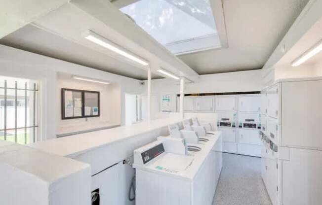 A white laundry room with a washer and dryer.