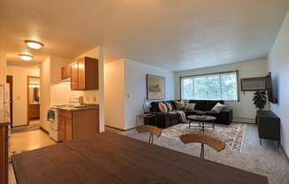 Fargo, ND Saddlebrook Apartments. a living room with a couch and a table