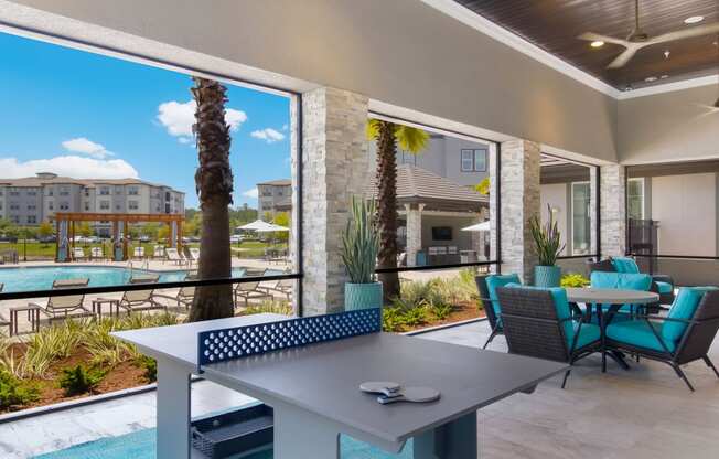 a patio with a table and chairs and a swimming pool