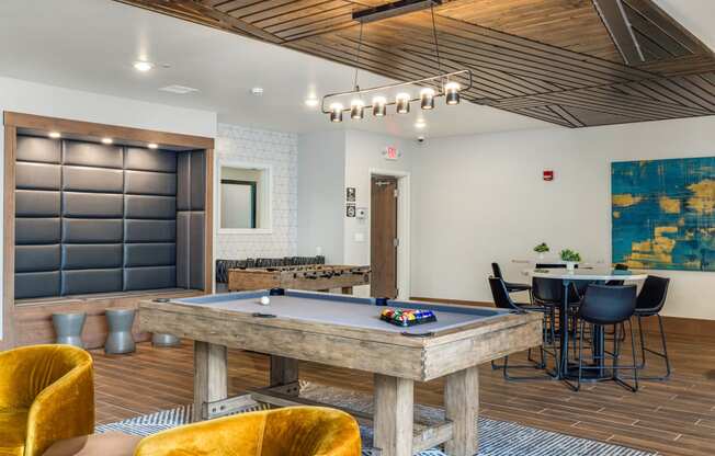 a game room with a pool table and a bar