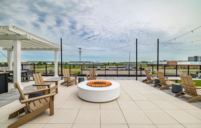 the terrace of a building with chairs and a fire pit at The Standard on 32nd, West Fargo, 58078