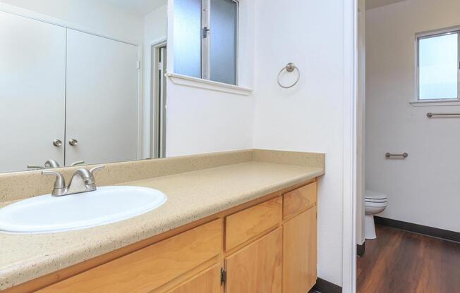 a kitchen with a sink and a mirror