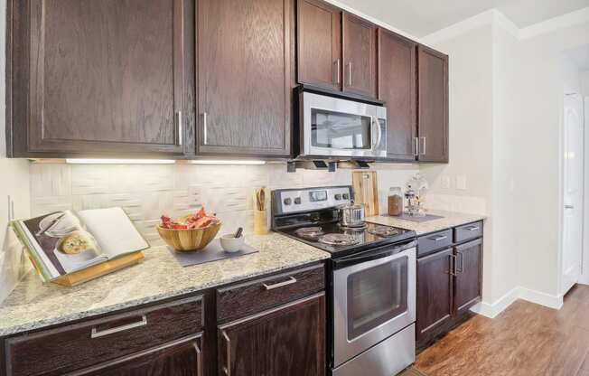 a kitchen with wooden cabinets and stainless steel appliances