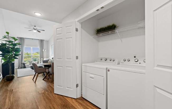 A white laundry room with a washer and dryer.