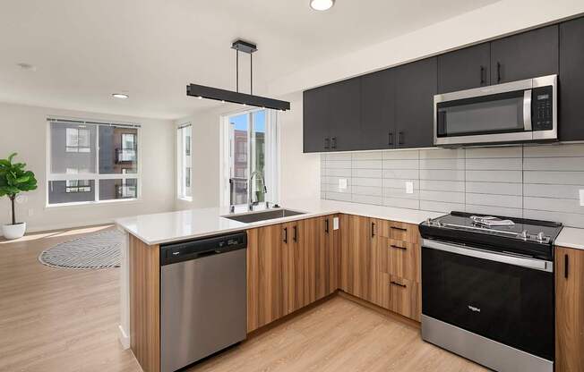 A modern kitchen with wooden cabinets and stainless steel appliances.