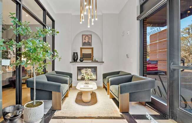 A living room with a grey couch and a fireplace.