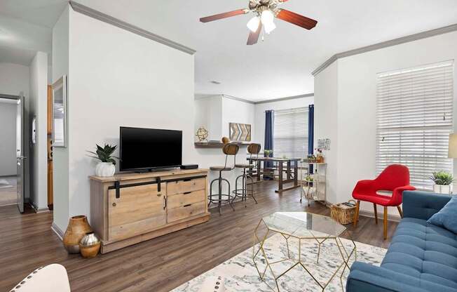 A living room with a TV, a sofa, and a coffee table.