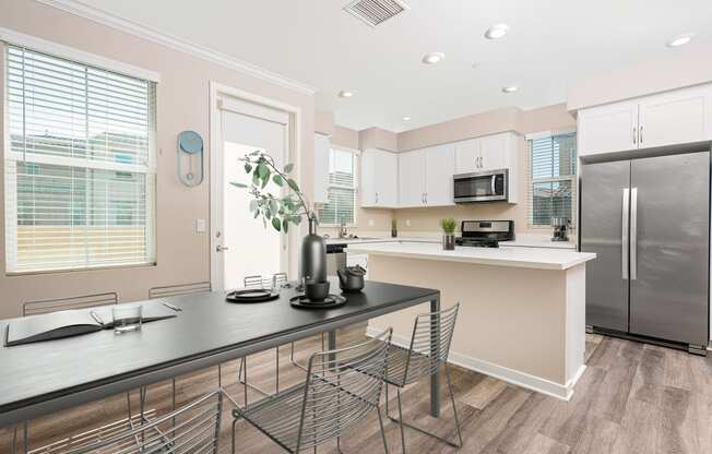 a kitchen with a large island and stainless steel appliances