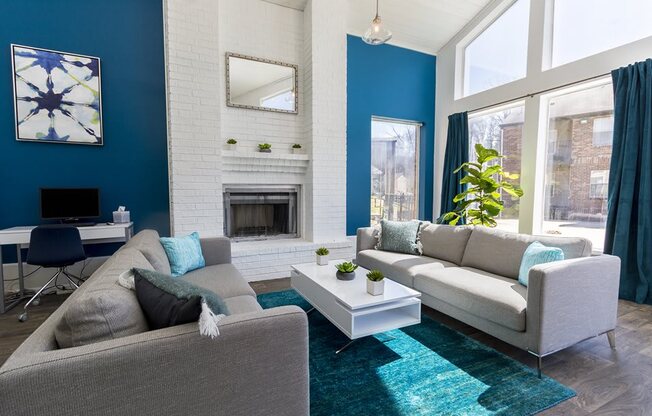a living room with blue walls and a white fireplace