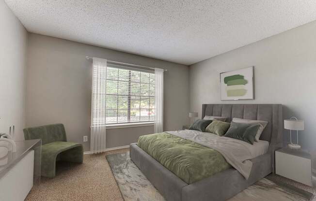 A bedroom with a large bed and a green chair.