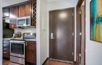 the doorway to a kitchen with a stainless steel stove and a refrigerator