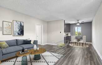 Spacious hardwood floor living room with view of dining area.