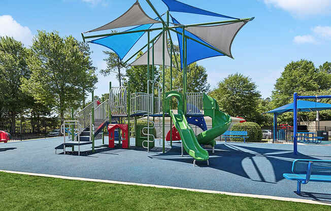 Community Playground with Slides and a Canopy at Retreat at Stonecrest Apartments located in Lithonia, GA.