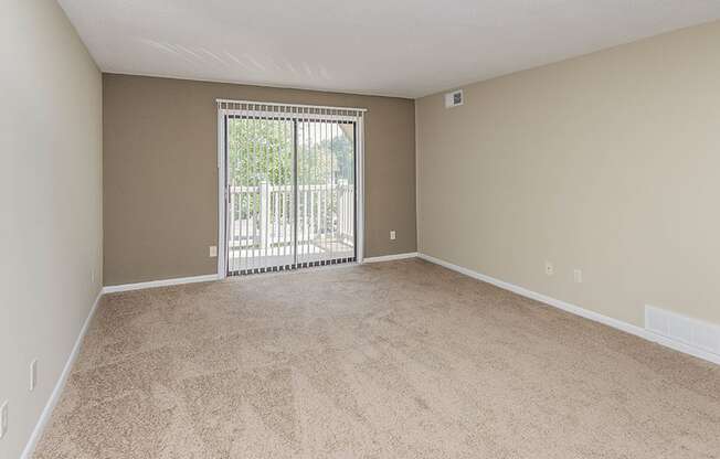 Room with carpeting and balcony access at bavarian woods apartments