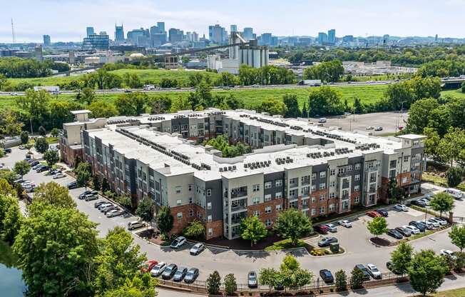 an aerial view of an apartment complex with a city in the background