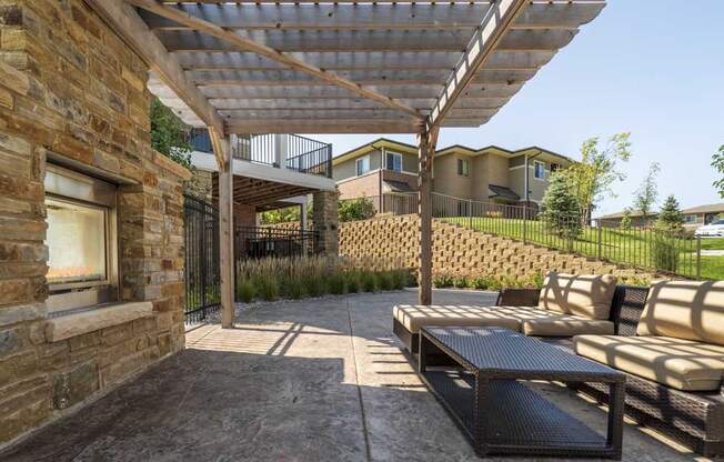 Outdoor fireplace with pergola and seating at Villas of Omaha townhome apartments in northwest Omaha NE 68116
