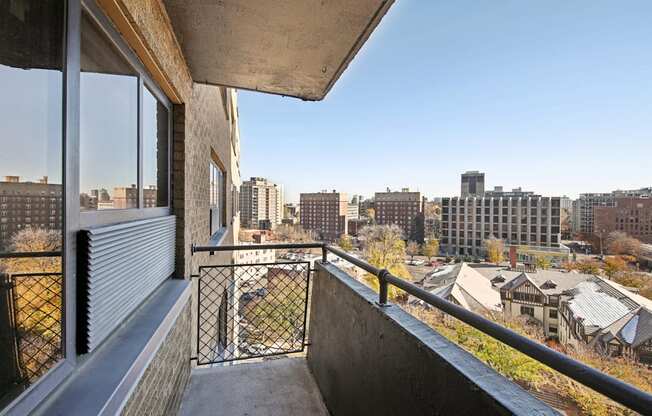 the view of the city from the balcony of a apartment