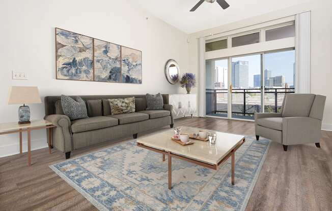 a living room with a couch and a coffee table and a window