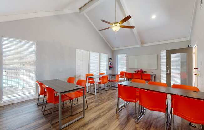 a dining room with tables and chairs and a ceiling fan