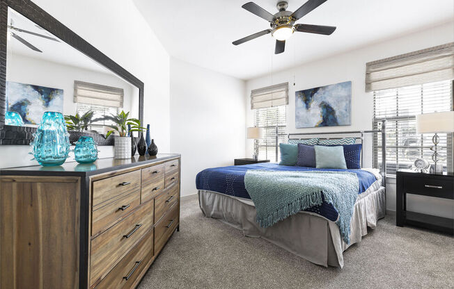 a bedroom with a bed and a ceiling fan