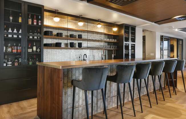 a bar in a restaurant with bar stools in front of it