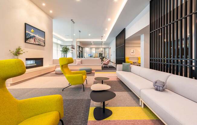 A modern living room with a yellow chair and a white sofa.
