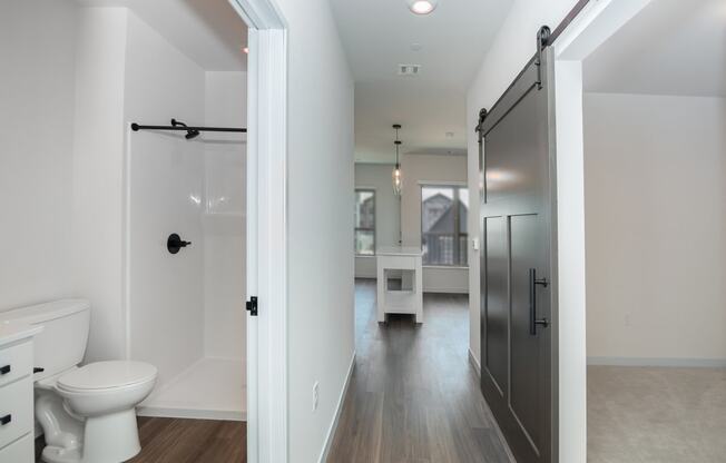 a bathroom with a white toilet and a black shower door at The Crossings at Windsong, Prescott Valley