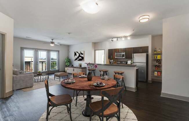 A modern dining room with a wooden table and chairs.