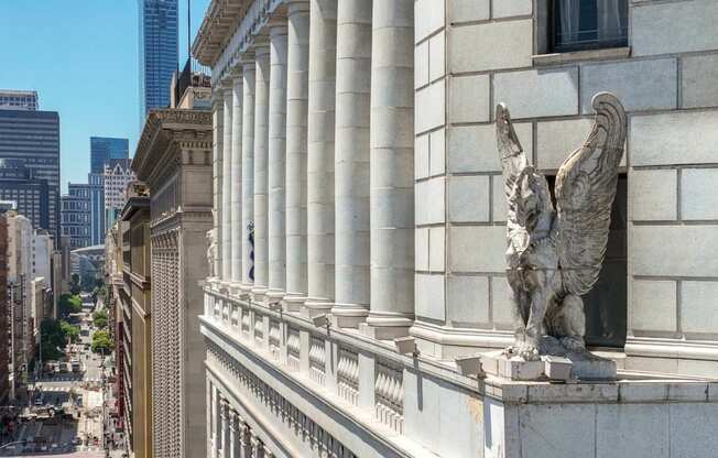 a statue of an eagle on the side of a building